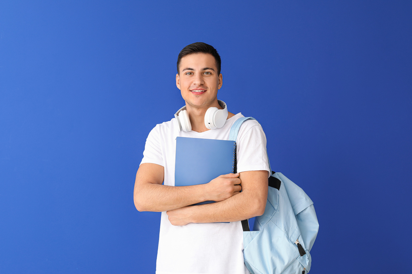 Portrait of Male Student on Blue Background